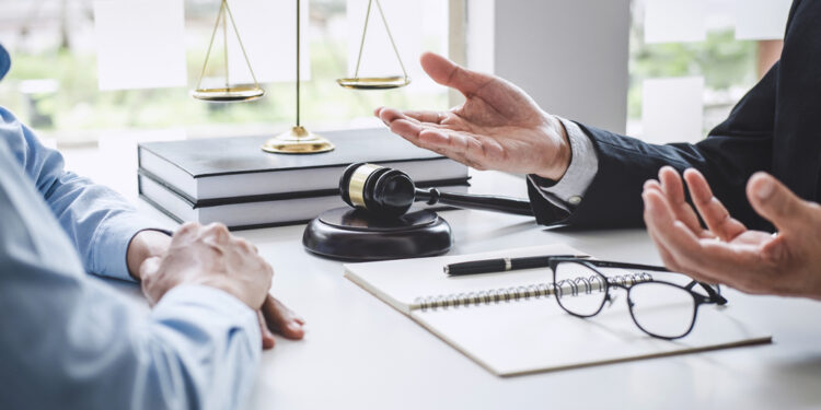 Consultation and conference of Male lawyers and professional businesswoman working and discussion having at law firm in office. Concepts of law, Judge gavel with scales of justice.