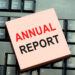 Text caption inspiration showing Annual Report Business concept for Financial Rating Record written on sticky note paper on black keyboard background - Pratama Institute Peran Strategis Tema dalam Laporan Tahunan Perusahaan