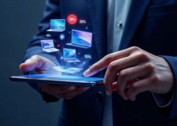 Businessperson using a tablet with floating holographic laptops and percentage icons indicating data/connection. l